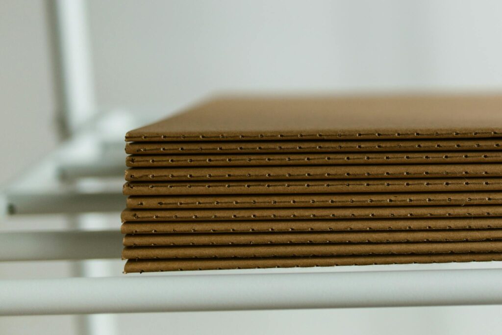 Maximizing Your Blog’s Reach: SEO Tips for Bloggers Close-up view of neatly arranged stacked cardboard sheets placed on a metal shelf, perfect for packaging concepts.
