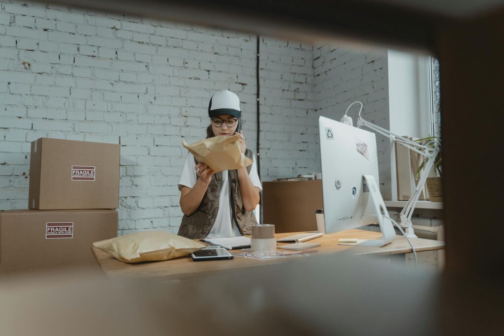 Never Run Out of Ideas: Top Tips for Generating Fresh Blog Topics Courier in modern office checking parcel with technology and shipping materials around.